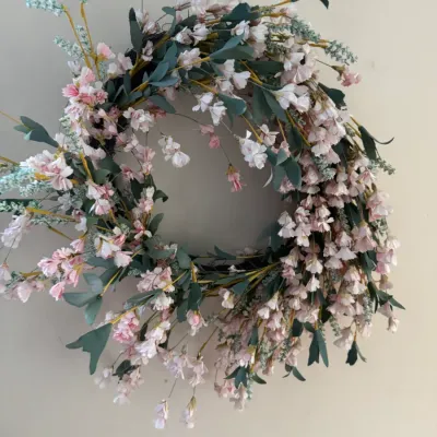 Sale Photo Thumbnail #155: Spring floral wreath featuring faux pink cherry blossoms, green foliage, and light blue accents.