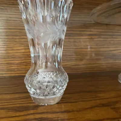 Sale Photo Thumbnail #168: Vintage cut glass bud vase featuring a scalloped rim, frosted floral etching, and a diamond-patterned bulbous base.