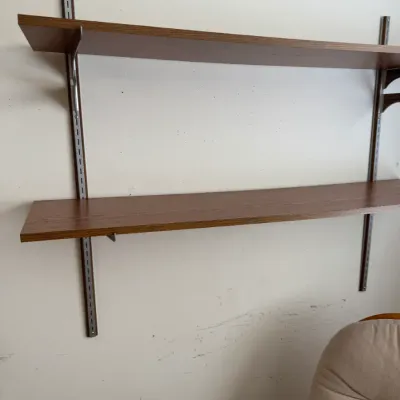 Mid-century modern style wall-mounted shelving unit featuring two wood-grain laminate shelves on adjustable metal standards.