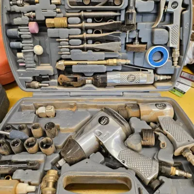 DAPC air tool kit in a molded gray plastic carrying case, showing signs of use and dust, including an impact wrench, air ratchet, air...