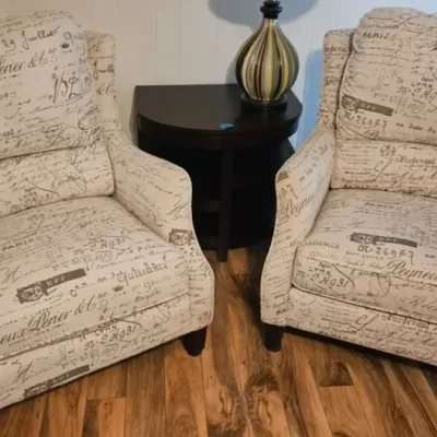 Pair of contemporary wingback armchairs upholstered in a cream fabric with a vintage French script and postmark pattern