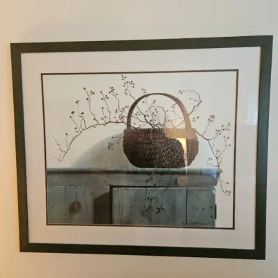 Framed and matted still life print by Pauline Eble Campanelli, depicting a woven basket with bittersweet branches resting on a rustic...