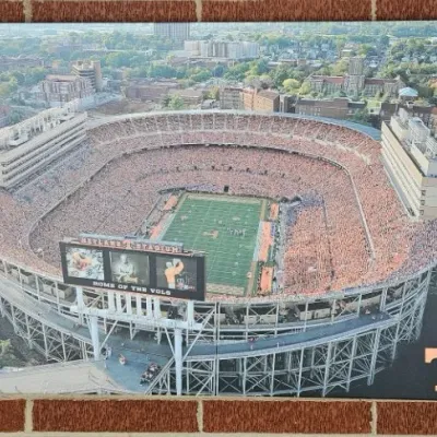 Aerial photograph print of Neyland Stadium, home of the Tennessee Volunteers, featuring a packed crowd and the University of Tennessee...