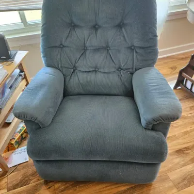 Vintage La-Z-Boy style recliner upholstered in a dusty blue corduroy fabric with a button-tufted backrest.