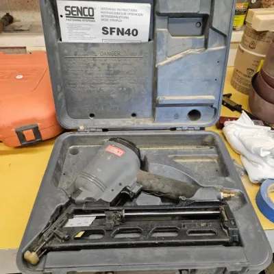 Senco SFN40 pneumatic finish nailer with its original hard plastic carrying case and operating instructions manual.