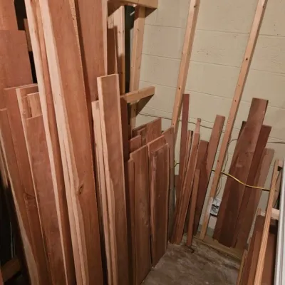 Assorted lumber and wood planks of varying lengths and widths, suitable for woodworking projects.