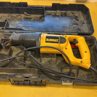 DeWalt corded reciprocating saw in its original black plastic carrying case, showing signs of moderate use.