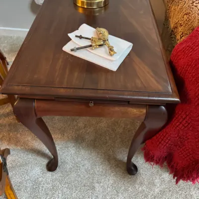 Sale Photo Thumbnail #259: Traditional Queen Anne style cherry wood end table featuring cabriole legs, a pull-out slide, and a sunburst veneer top.