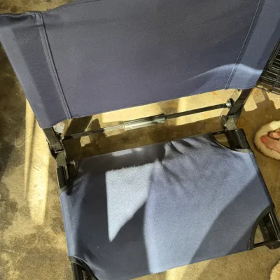 Sale Photo Thumbnail #207: Folding stadium seat with a black metal frame and navy blue canvas backrest and seat cushion.