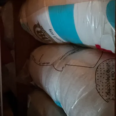 Sale Photo Thumbnail #197: Two rolls of polyester fiberfill batting, still sealed in their original plastic packaging.