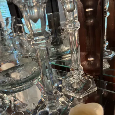 Sale Photo Thumbnail #241: Pair of vintage clear pressed glass candlesticks with hexagonal bases, displayed on a glass shelf.