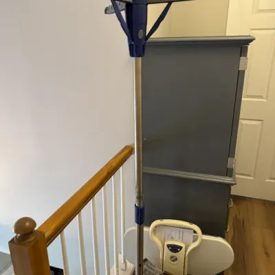 Sale Photo Thumbnail #176: Collapsible tripod clothes drying rack with blue plastic accents and a stainless steel pole.