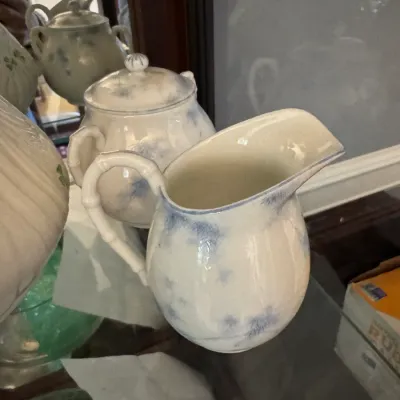 Sale Photo Thumbnail #240: Vintage ceramic pitcher and matching lidded sugar bowl featuring a blue and white mottled design with bamboo-style handles.