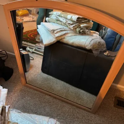 Sale Photo Thumbnail #138: Mid-century modern style dresser mirror with an arched light wood frame, shown resting on the floor.
