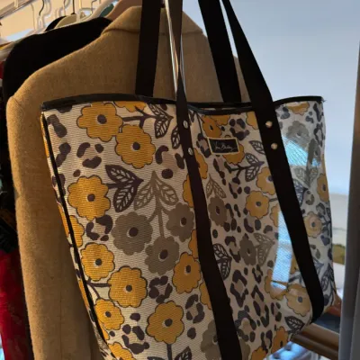 Sale Photo Thumbnail #155: Vera Bradley mesh tote bag featuring a yellow and grey floral pattern with leopard print accents and black shoulder straps.