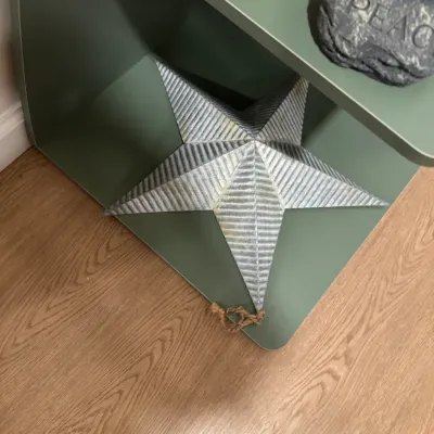 Rustic corrugated galvanized metal barn star wall hanging, featuring a jute rope loop for hanging.