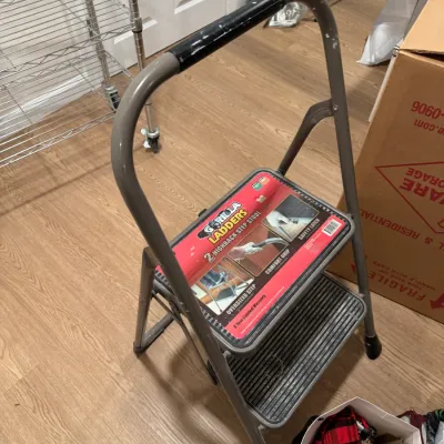 Sale Photo Thumbnail #112: Gorilla Ladders 2-step highback folding step stool with a comfort grip handle and oversized steps.
