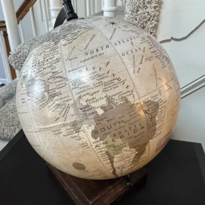 Vintage-style desk globe featuring a sepia-toned map on a dark wooden base.