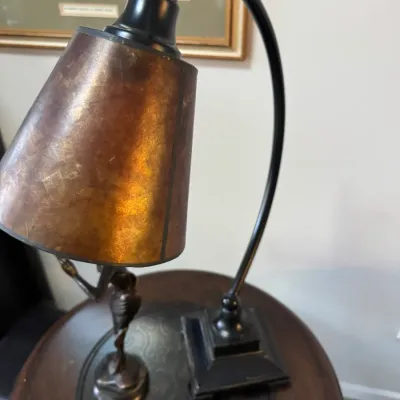 Vintage-style gooseneck desk lamp with a dark metal frame and a warm, amber-toned mica shade.