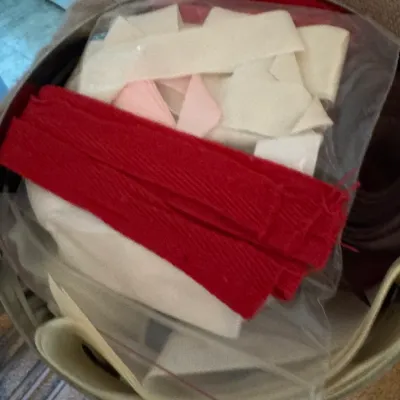Sale Photo Thumbnail #151: Assorted sewing notions and fabric trim, including red and cream-colored bias tape, packaged in a clear plastic bag.