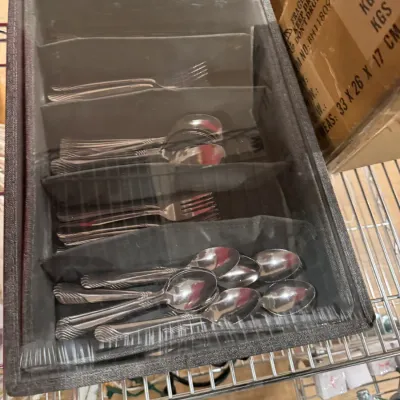 Stainless steel flatware set with ribbed handles, organized in a grey fabric storage chest with a clear plastic window.