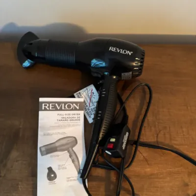 Sale Photo Thumbnail #171: Revlon full-size hair dryer in black, complete with its original instruction manual and safety tag.