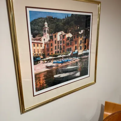 Sale Photo Thumbnail #283: Large framed art print depicting a scenic European coastal village with boats, matted and housed in a gold-toned metal frame.