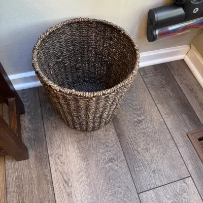 Sale Photo Thumbnail #232: Round woven seagrass wastebasket in a dark brown and natural finish, showing light wear.