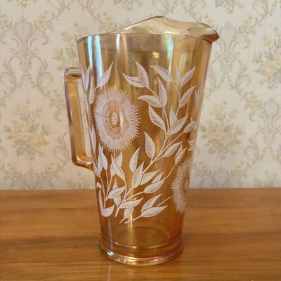 Sale Photo Thumbnail #443: Mid-Century Marigold Carnival Glass Water Pitcher with White Floral Decoration and Ice Lip