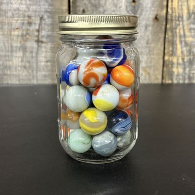 Sale Photo Thumbnail #551: A Collection of Vintage Glass Marbles in a Graduated Glass Jar