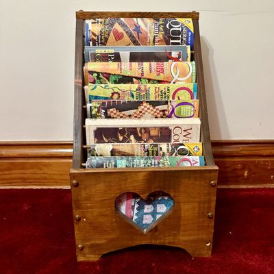 Sale Photo Thumbnail #499: A Collection of Quilting Periodicals and Books in a Wooden Heart Magazine Rack