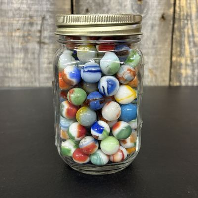 Sale Photo Thumbnail #652: A Collection of Vintage Glass Marbles in a Graduated Glass Jar