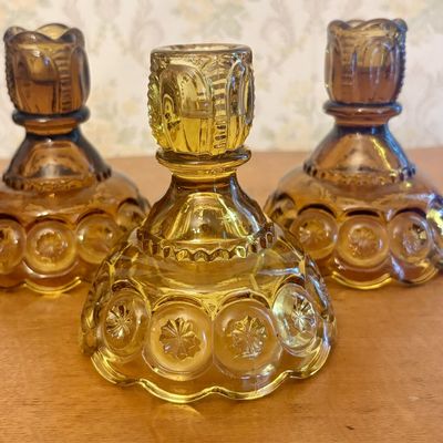A Trio of Amber Pressed Glass Moon and Star Candlesticks