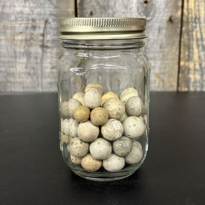 Sale Photo Thumbnail #657: A Collection of Antique Clay Marbles in a Glass Jar