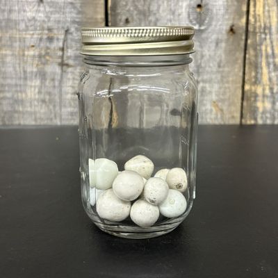 Sale Photo Thumbnail #648: A Collection of Vintage Clay and Glass Marbles in a Graduated Glass Jar