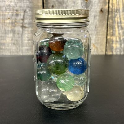 Sale Photo Thumbnail #651: A Collection of Vintage Glass Marbles in a Graduated Glass Jar