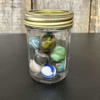 Sale Photo Thumbnail #763: An Assortment of Vintage Glass Marbles in a Clear Glass Jar