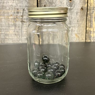 Sale Photo Thumbnail #439: A Collection of Black Galaxy Glass Marbles in a Graduated Glass Jar