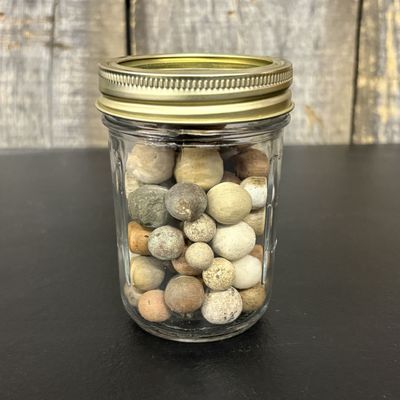 Sale Photo Thumbnail #766: A Collection of Antique Clay Marbles in a Glass Canning Jar