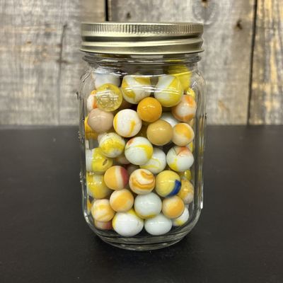 Sale Photo Thumbnail #561: A Collection of Vintage Glass Marbles Housed in a Measuring Jar