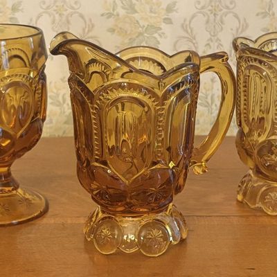 Three Piece Amber Pressed Glass Creamer Spooner and Goblet Set in Moon and Star Pattern