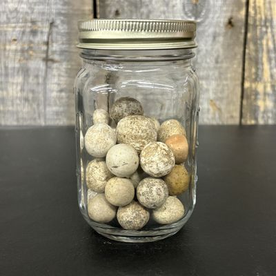 Sale Photo Thumbnail #664: A Collection of Vintage Clay Marbles in a Glass Storage Jar