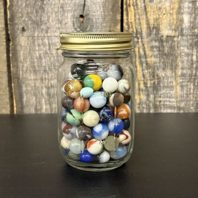 Sale Photo Thumbnail #306: A Collection of Vintage Glass Marbles in a Graduated Glass Storage Jar