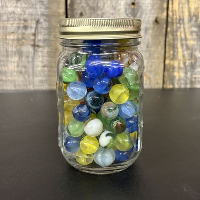 Sale Photo Thumbnail #558: An Assortment of Vintage and Modern Glass Marbles in a Glass Jar
