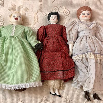 Sale Photo Thumbnail #490: A Trio of Glazed Porcelain Head Dolls in Period Style Dress