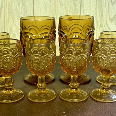 Sale Photo Thumbnail #695: A Ten Piece Collection of Amber Pressed Glass Moon and Star Pattern Tableware