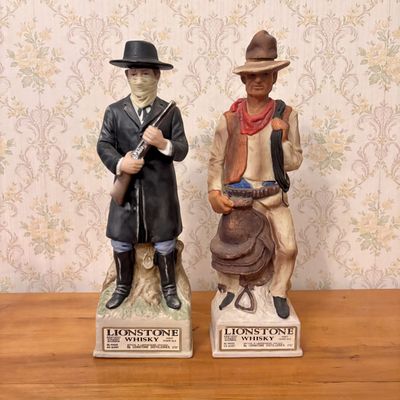 Sale Photo Thumbnail #378: A Pair of Lionstone Whiskey Western Commemorative Porcelain Decanters