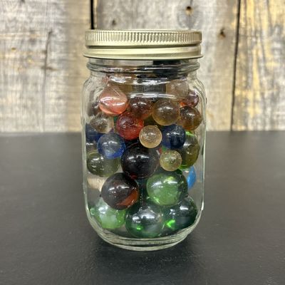 Sale Photo Thumbnail #654: A Collection of Assorted Vintage Glass Marbles in a Graduated Mason Jar