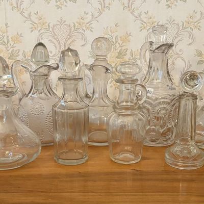 Sale Photo Thumbnail #640: Eleven Vintage Amber and Clear Glass Cruets and Decanters Including Novelty Telephone Bottle