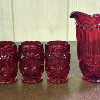 Sale Photo Thumbnail #700: A Set of Ruby Red Moon and Star Pattern Miniature Glass Pitcher and Tumblers